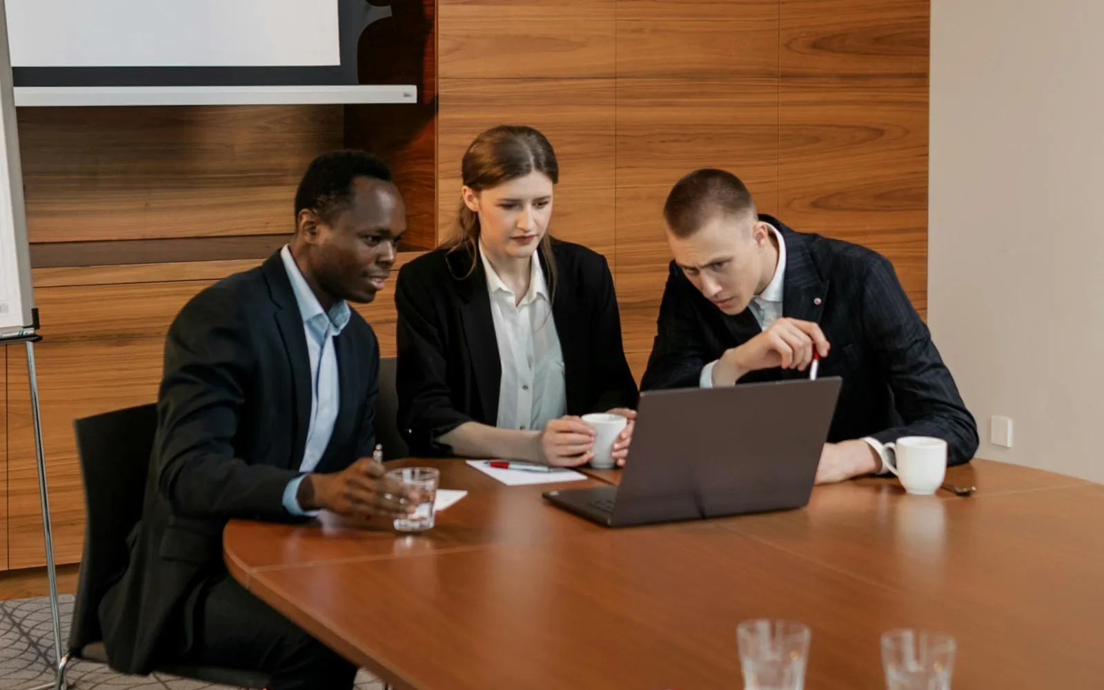 School administrators collaborating around a laptop